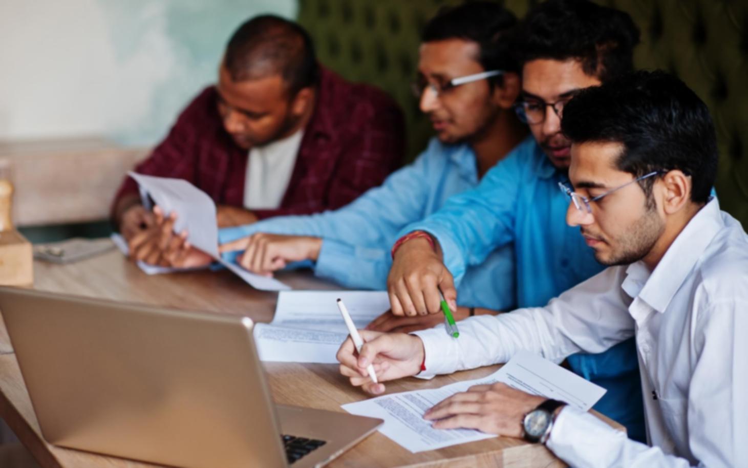 Business professionals reviewing financial ratio reports and metrics